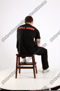 Alex Sitting With Pistol Pose